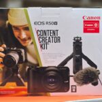 Canon EOS R50V Content Creator Kit — mirrorless camera with lens, tripod, mic, and SD card Bluescale